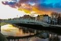 Dublin night scene with Ha`penny bridge and Liffey river lights