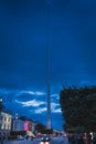 Dublin Spire at night with blurred people and cars