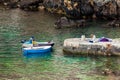 Fisherman posing for a young woman painter at Dubrovnik West Pier