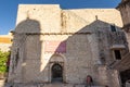Dubrovnik, Croatia - Aug 22, 2020: Facade of City Wall entrance in old town in morning sunrise hour