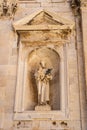 Dubrovnik, Croatia - Aug 20, 2020: Saint statue with a baby on Stradun street in old town in summer
