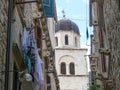 Dubrovnik church tower viewed from washing lined street