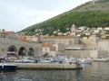 Dubrovnik old town harbour view of new town in background with boats in forground