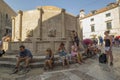 People rest and quench their thirst near the fountain with water in Dubrovnik Royalty Free Stock Photo