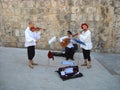 Dubrovnik, Croatia, August 5, 2010. Street musicians play musical instruments. Traditional white shirts, red berets. Costume of