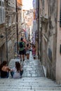 View of people on a narrow street with steep stairs in the old town of Dubrovnik Croatia Royalty Free Stock Photo