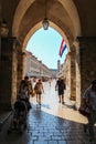 A view down the Stradun main street in Dubrovnik, with a Croatian flag flying Royalty Free Stock Photo