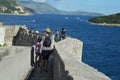 Tourists walking on the city wall of old town Dubrovnik, Croatia