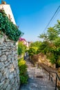 Dubrovnik panorama view from small old street with green trees on the side. Sea in background Royalty Free Stock Photo