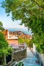 Dubrovnik panorama view from small old street with green trees on the side. Sea in background Royalty Free Stock Photo