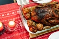 Duck baked until crispy with potatoes and apples on the Christmas table.