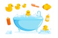 Duck and bath with combs and foam. Bathing set with tub, cosmetics, yellow rubber ducks isolated in white background Royalty Free Stock Photo