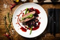 Duck breast with asparagus, salad and sauce on white plate. Delicious healthy grilled and roasted bird fillet food Royalty Free Stock Photo