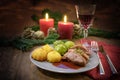 Duck breast with duchess potatoes, brussels sprout and sauce, served as a festive christmas dinner with red wine, napkin and Royalty Free Stock Photo