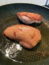 Duck breasts cooking in a pan