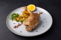 Duck leg confit with Brussels sprouts, baked potatoes, thyme and orange. Traditional French cuisine. Selective focus. Royalty Free Stock Photo