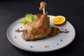 Duck leg confit with Brussels sprouts, baked potatoes, thyme and orange. Traditional French cuisine. Selective focus. Royalty Free Stock Photo