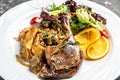 Duck leg confit meat portion of prepared with baked potatoes, mushrooms and onions, top view Royalty Free Stock Photo