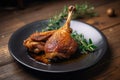 duck leg on plate, fried skin crispy and salty