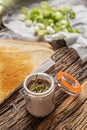 Duck liver mousse in a jar with toasts and sliced spring onion