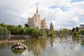 Ducks on pond in Zoo against Stalin skyscraper 7.07.2018