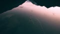 Ducks swim on a mirrored smooth mountain lake