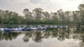 Ducks swimming and boats moored in the Lanca Ayala di Vigevano on the Ticino river