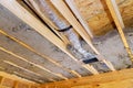 Ductwork installation with insulation visible in a residential ceiling under construction Royalty Free Stock Photo