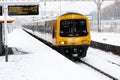 A West Midlands passenger train at a snow covered station