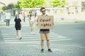 Dude with sign - man stands protesting things that annoy him