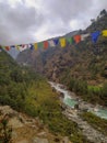 Dudh Koshi snow river in mountain valley and colorful prayer flags in Nepal Royalty Free Stock Photo