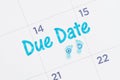 Due Date message on a monthly calendar with tiny baby footprints Royalty Free Stock Photo