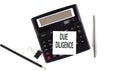 DUE DILIGENCE text on sticker on calculator with pen,pencil on the white background