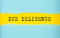 DUE DILIGENCE text on the torn paper , yellow background