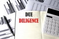 DUE DILIGENCE text written on a notebook on chart and diagram