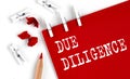 DUE DILLIGENCE text on red paper with office tools on white background Royalty Free Stock Photo