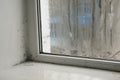 due to the increased humidity of the window, black mold appears on the wall Royalty Free Stock Photo