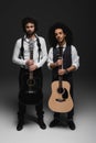 duet of handsome young musicians with acoustic guitars