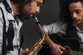 duet of jazzmen playing sax and acoustic guitar