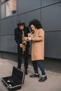 duet of stylish street musicians playing trumpet