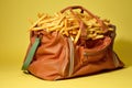 a duffle bag unzipped at the top, showing french fries