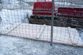 Dug and fenced deep hole or trench on the sidewalk in winter