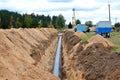 A Dug trench in the ground for the installation and installation of industrial gas and oil pipes Royalty Free Stock Photo