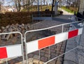 Dugged walkway and hole in the pavement. The protection block. Park with trees Royalty Free Stock Photo