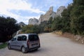 A small car repeats the silhouette of the huge Qatari castle Peyrepertuse