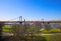 View over green pasture pensinsula MÃÂ¼hlenweide at river rhine on Friedrich Ebert bridge against blue sky in winter