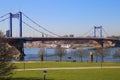 View over green pasture pensinsula MÃÂ¼hlenweide at river rhine on Friedrich Ebert bridge against blue sky in winter