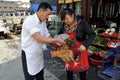 Dujiangyan, China: Cooks Weighing Chicken Royalty Free Stock Photo