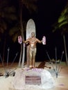 Duke Kahanamoku statue holding leis at Waikiki Beach at night Royalty Free Stock Photo