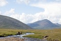 Dukha Boy rides reindeer across river